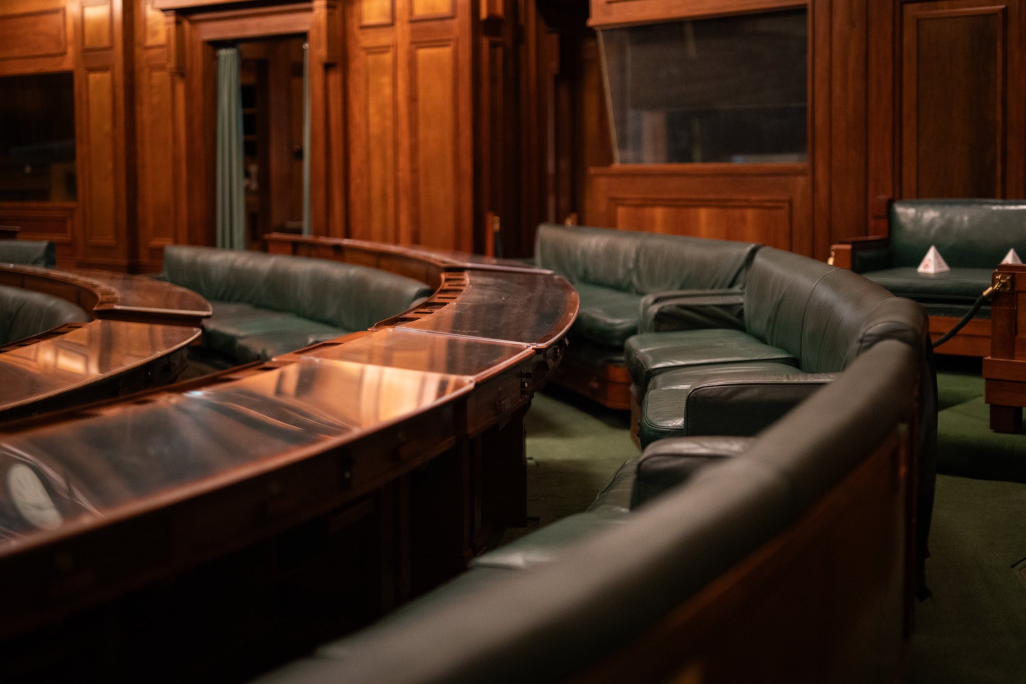 An empty tiered wooden hearing chamber